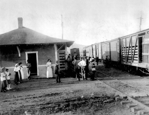 WOODROW DEPOT/POST OFFICE PHOTOGRAPH



- Bill Holbrook donated the black and white photograph from the Charles Cathey collection of one of the only known extant pictures of the early 1900s Woodrow Depot/Post Office.  The photo reveals only one end of the building, but it clearly shows railcars and people of the era who were there to collect their mail or else board the jitney that transported travelers from Canton to Sunburst and Spruce.  The building is named for President Woodrow Wilson who was President during the 1914-1927 era the structure existed.  The “Woodrow” name still exists on maps today.